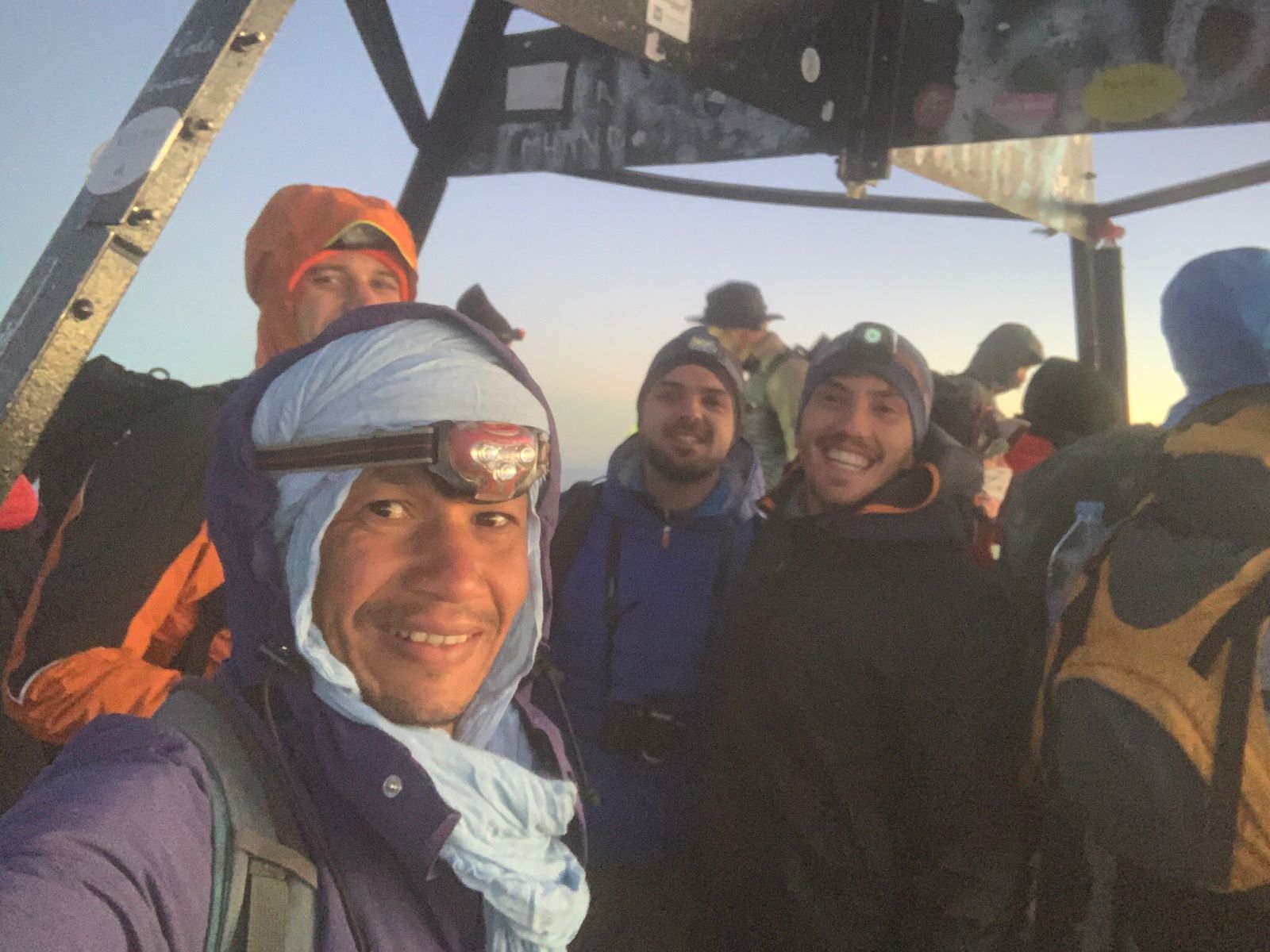 Mouloud with tourists at a mountain summit