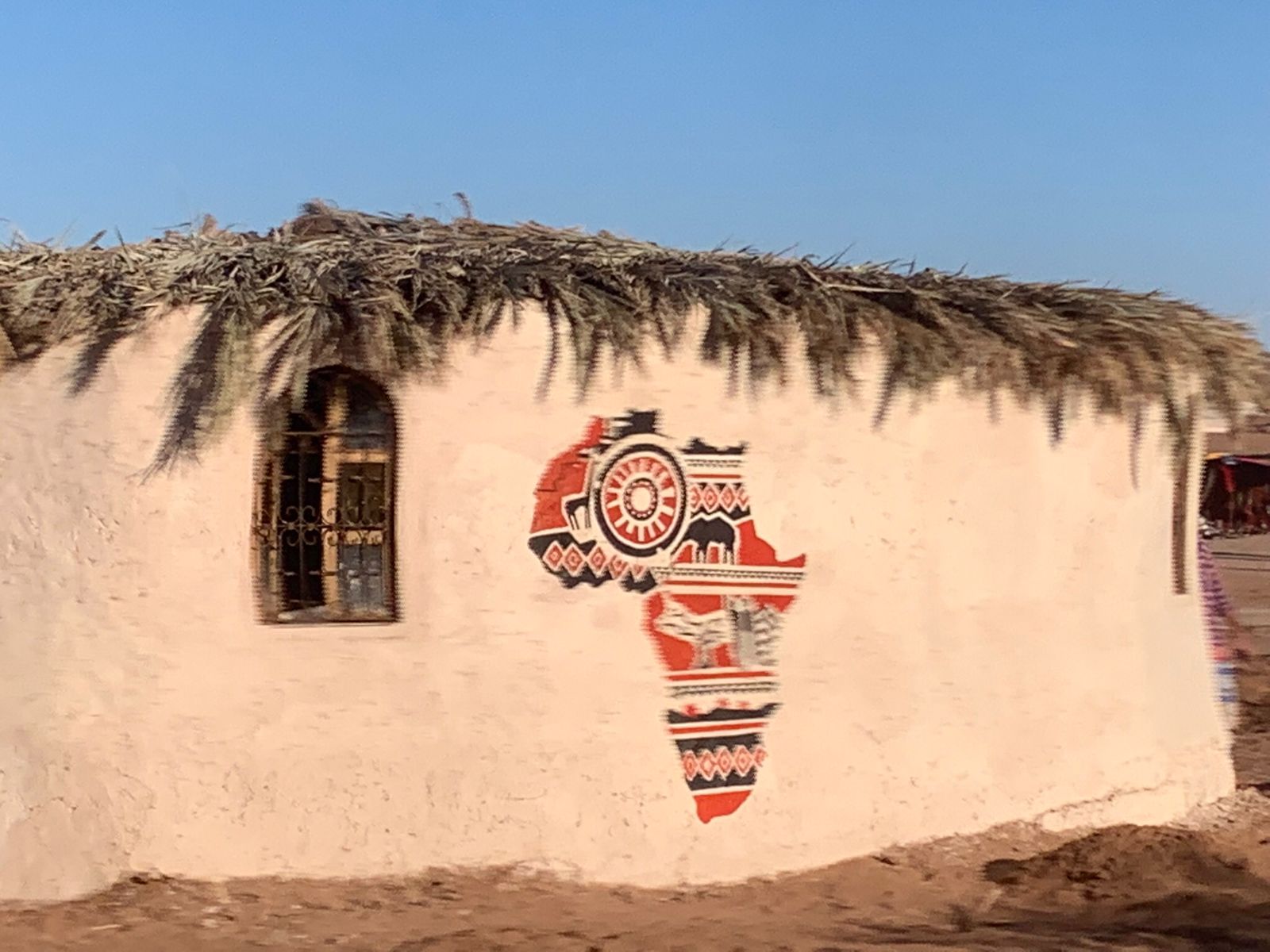 Colourful Africa mural on a desert building in southern Morocco